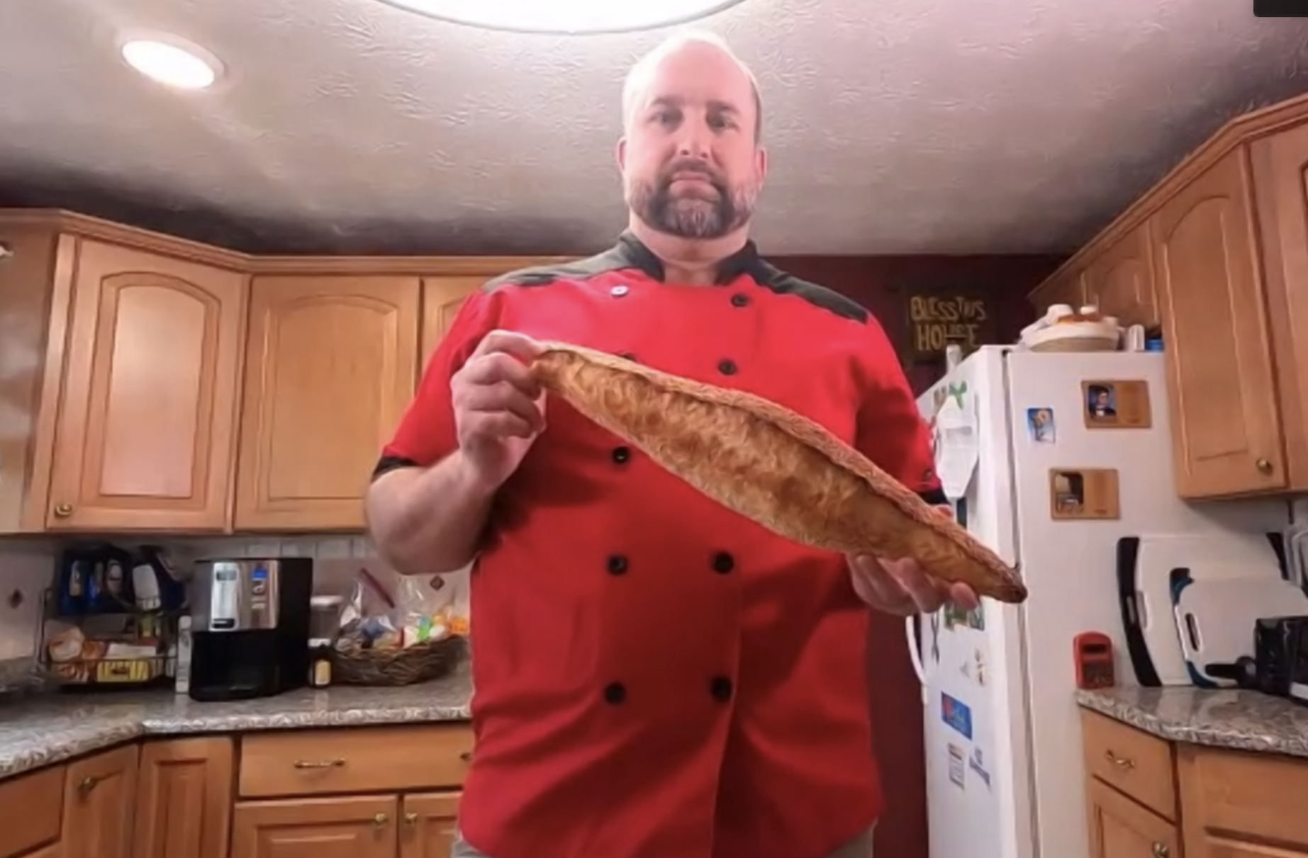 Staff hosts a cooking demo, holding a loaf of bread